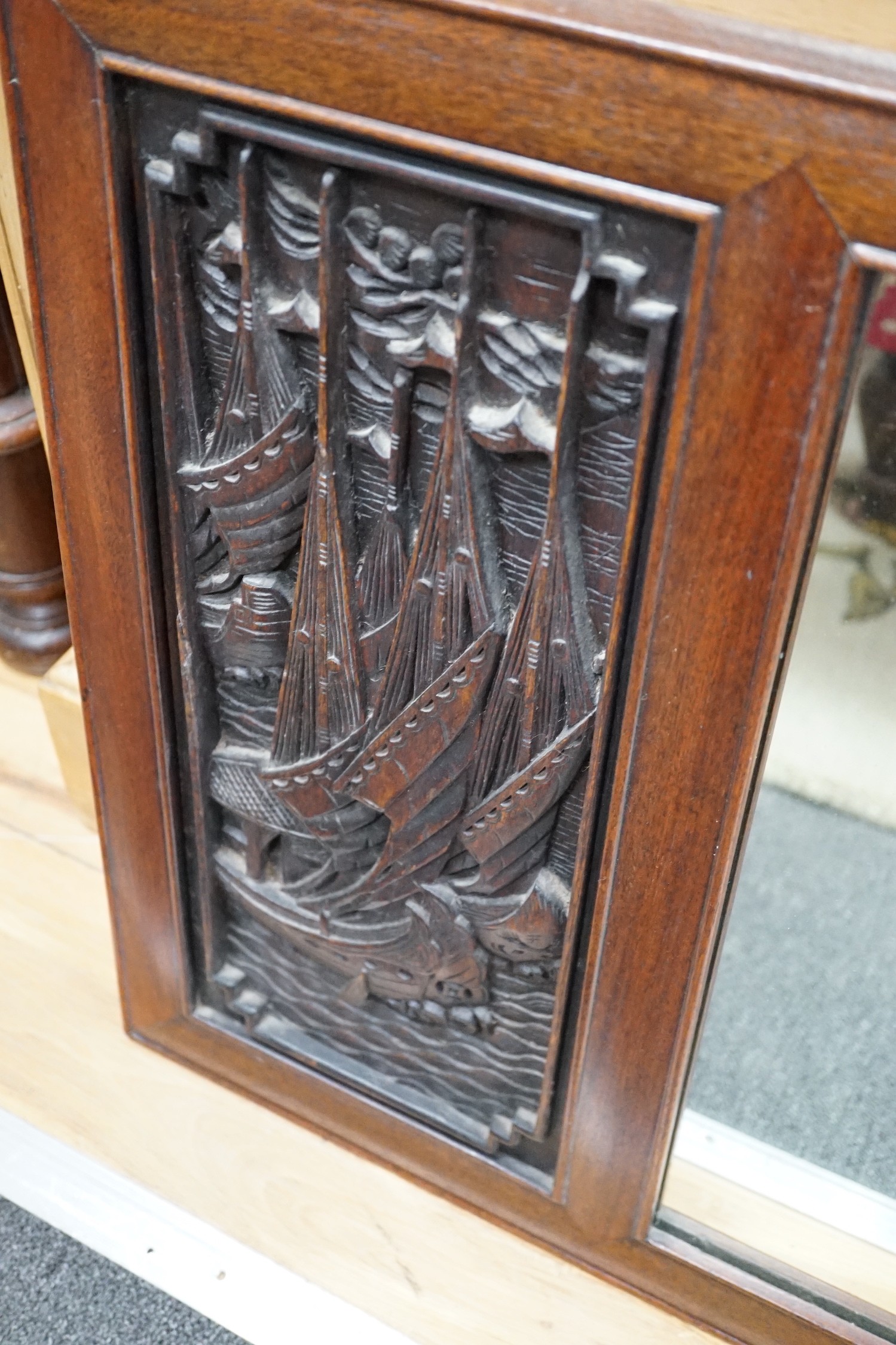 A Chinese hardwood relief carved wall mirror, width 114cm, height 53cm *Please note the sale commences at 9am.